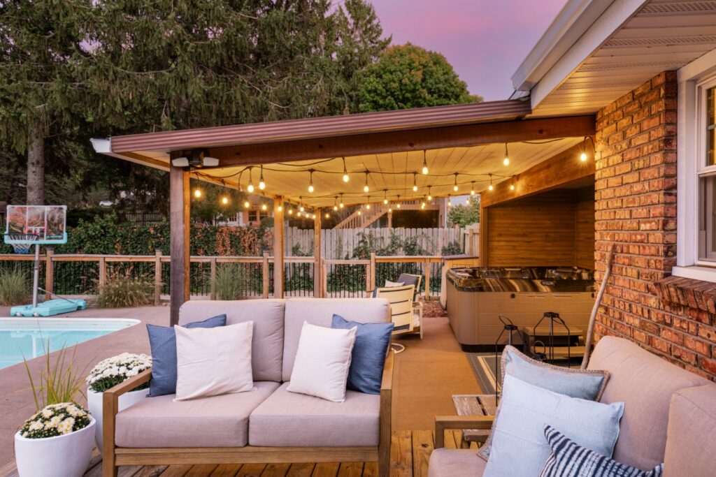 Cozy backyard patio with lights and pool