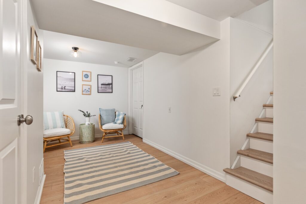 Cozy basement sitting area with wooden stairs