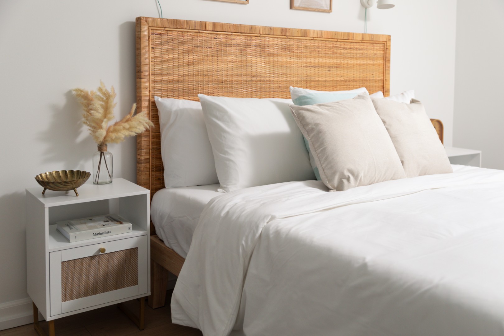 Cozy bedroom with wicker headboard and white bedding