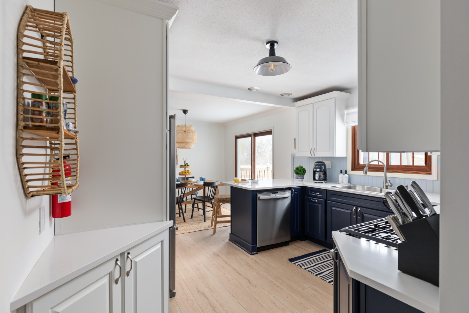 Modern kitchen with navy cabinets and dining area