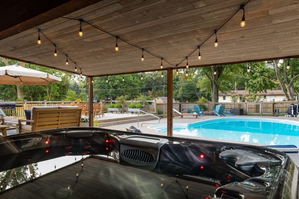 Backyard pool and patio with string lights