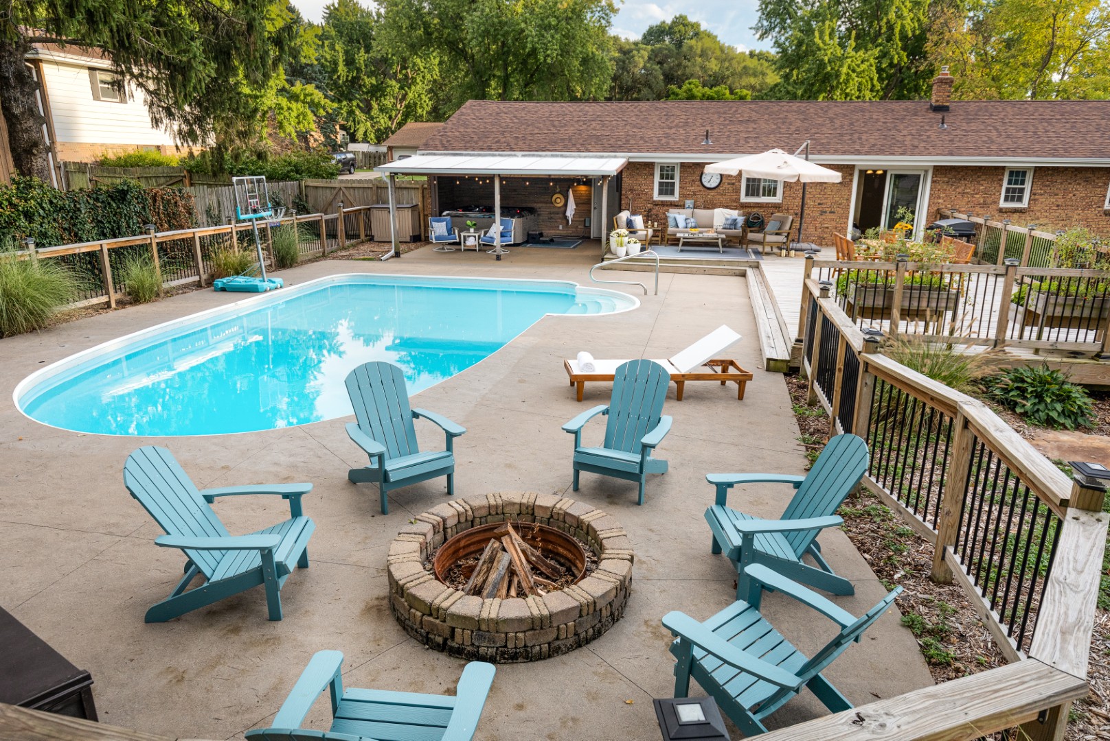 Backyard pool with fire pit and patio seating