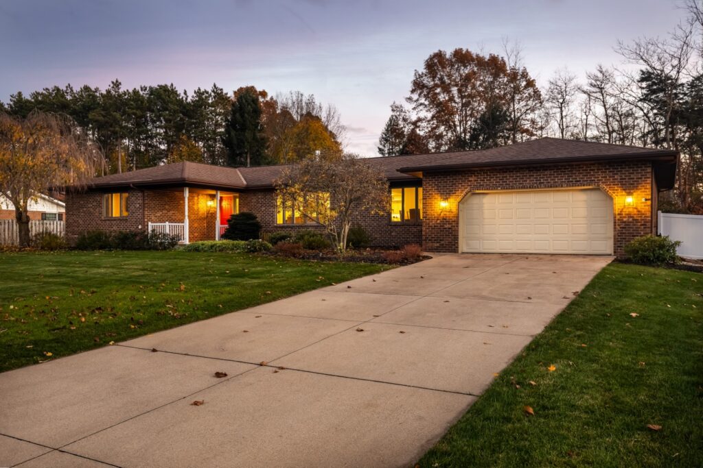 Brick house with garage at sunset