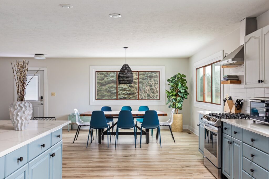 Modern kitchen and dining area with blue chairs