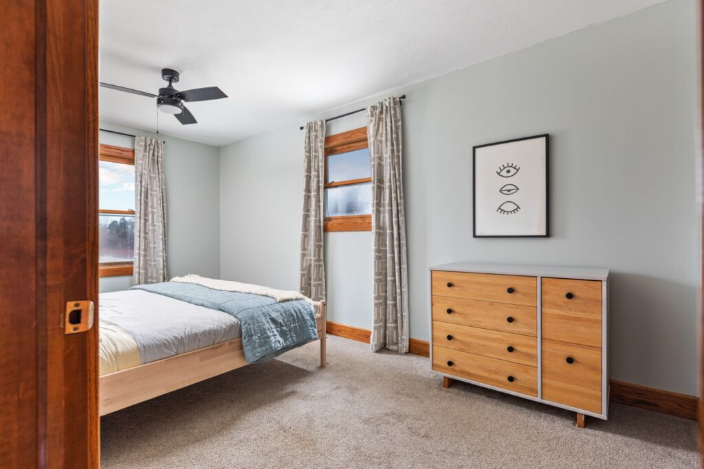 Modern bedroom with wooden furniture and artwork
