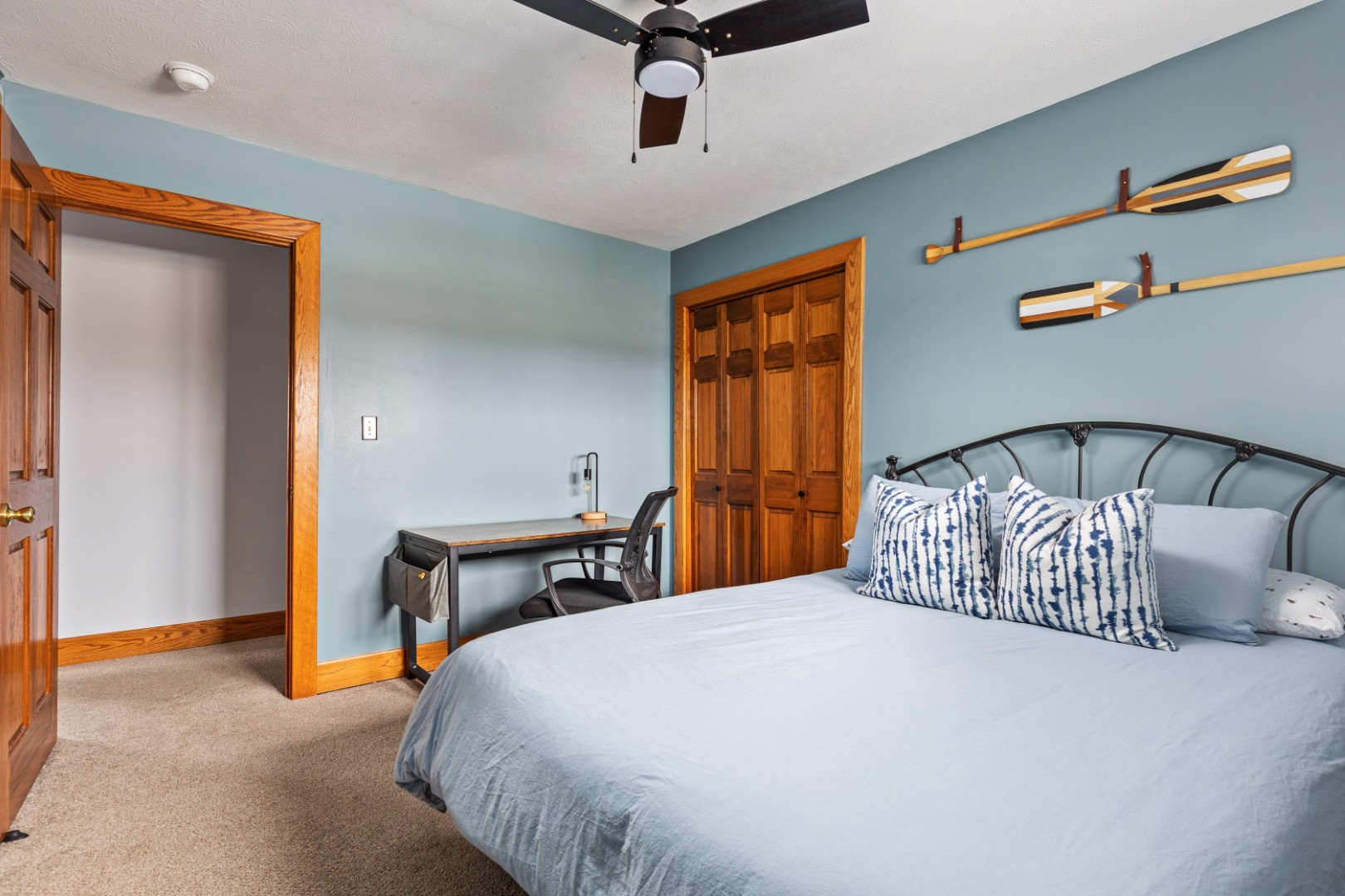 Cozy bedroom with desk and blue walls