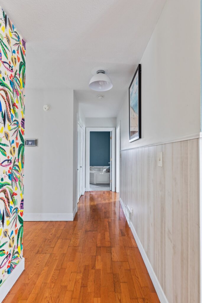 Bright hallway with wooden floor and colorful wallpaper
