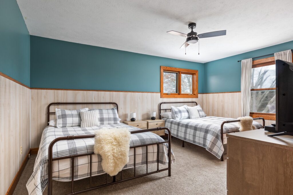 Cozy bedroom with two plaid double beds