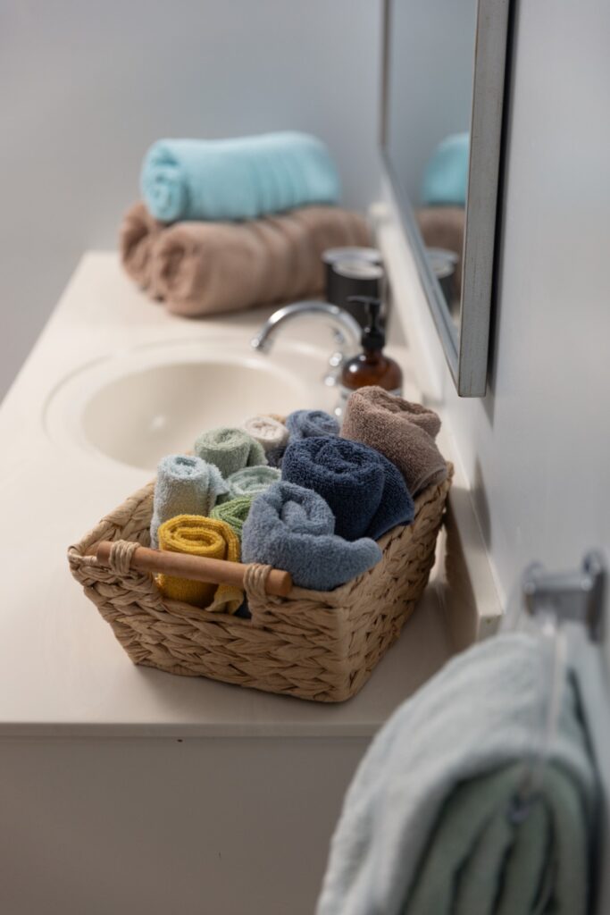 Rolled towels in basket on bathroom counter