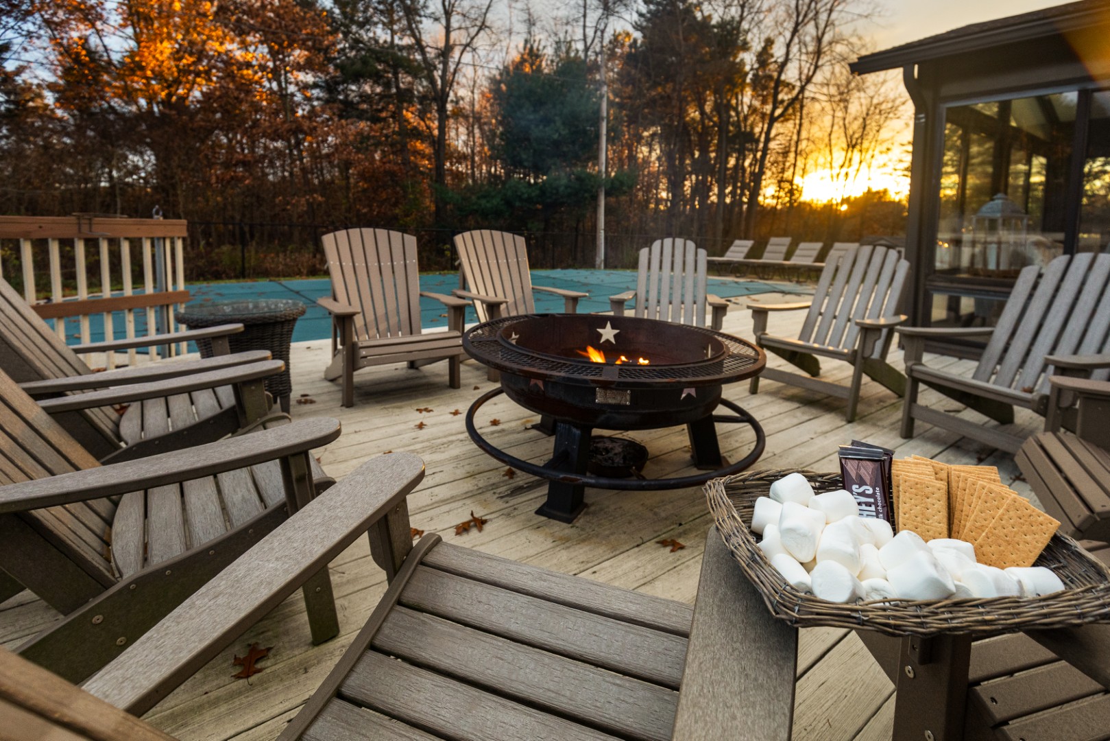 Outdoor fire pit with chairs and s'mores ingredients