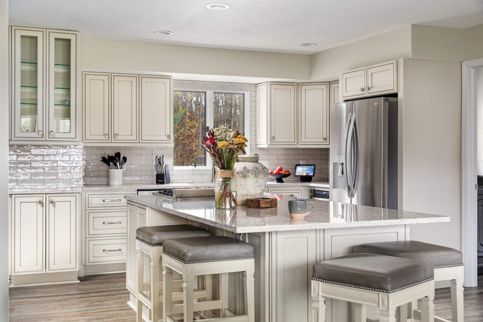 Modern kitchen with white cabinets and island seating