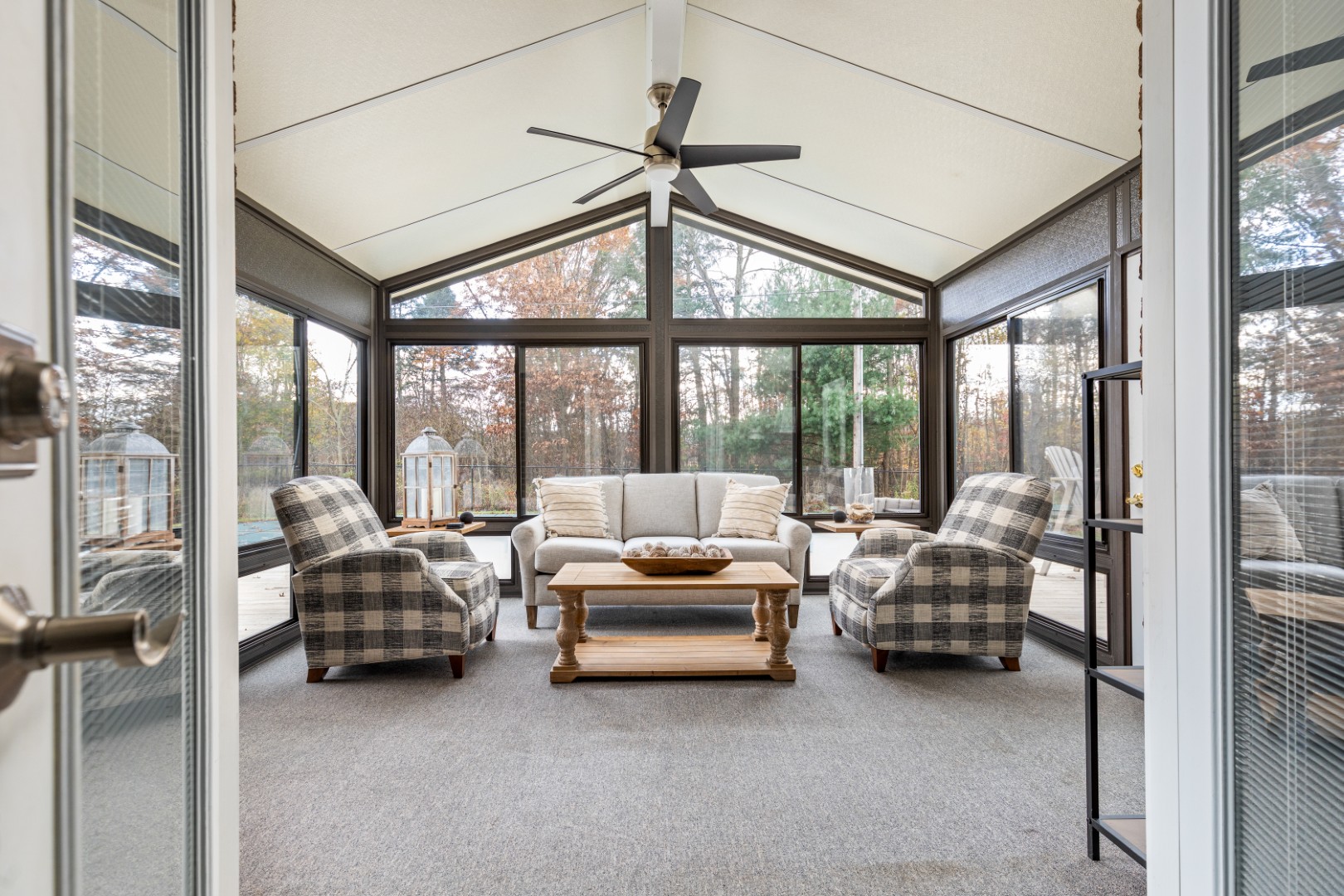 Bright sunroom with modern furniture and large windows
