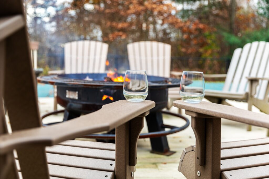 Outdoor fire pit with chairs and wine glasses