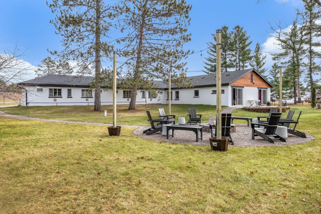 Outdoor fire pit area behind modern house