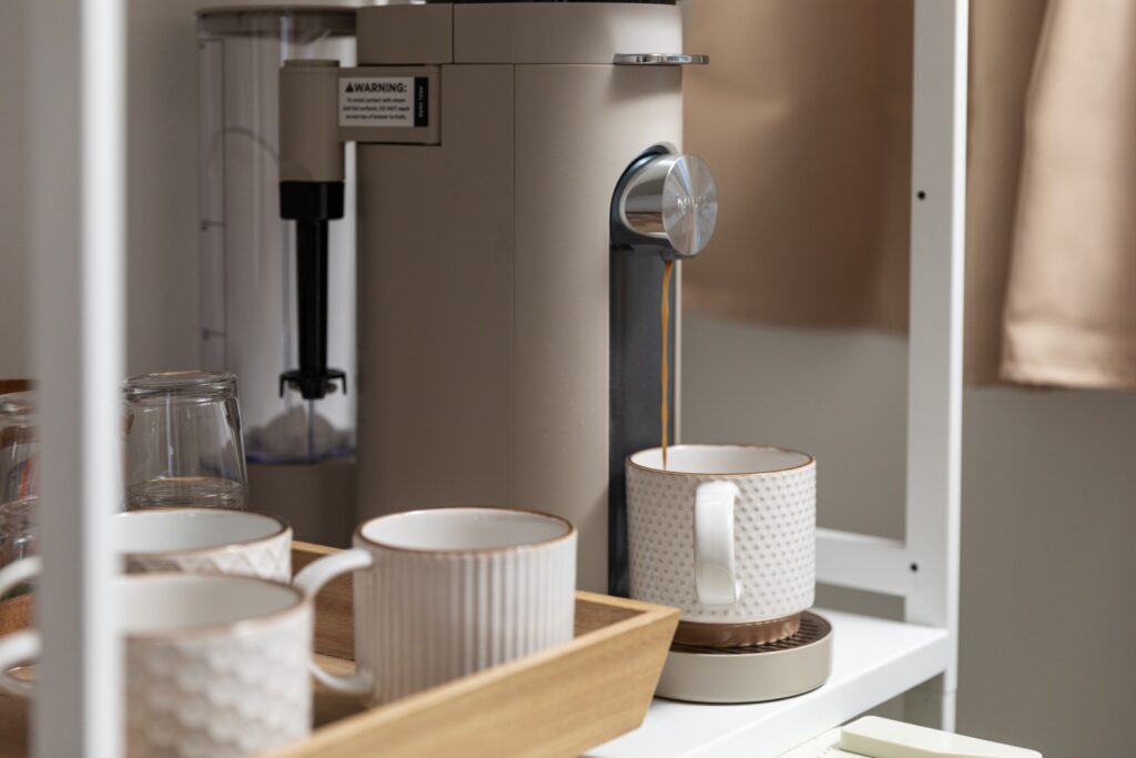 Coffee machine brewing coffee into ceramic mug