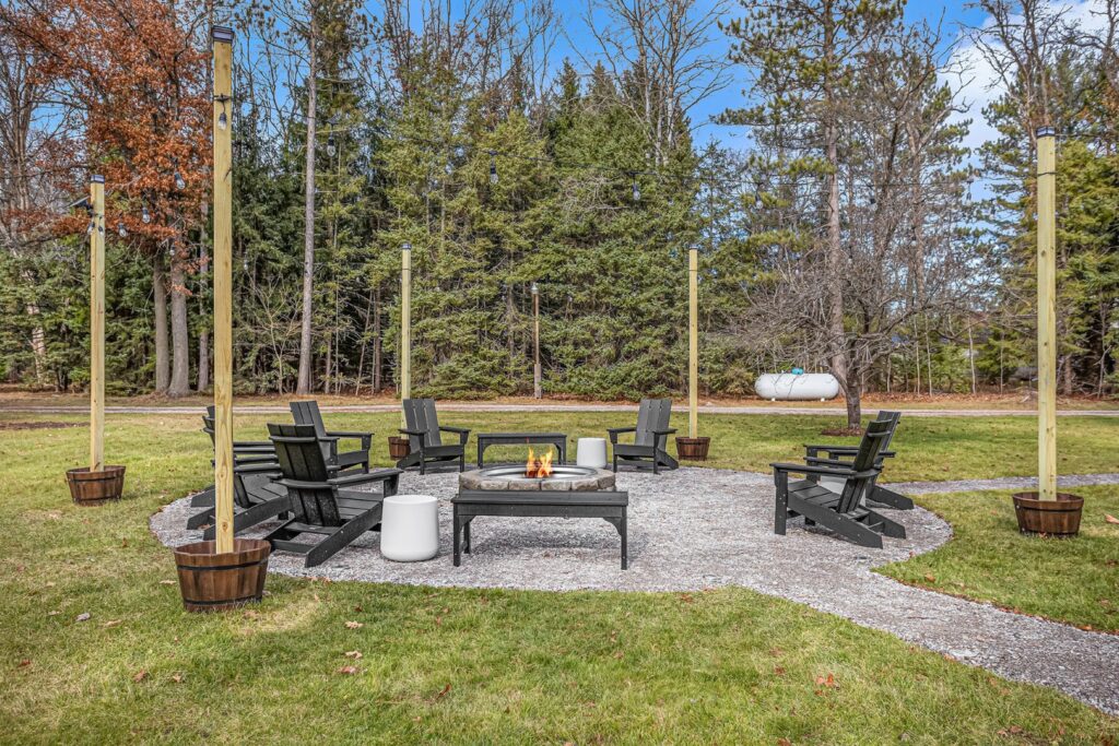 Outdoor fire pit with chairs and string lights