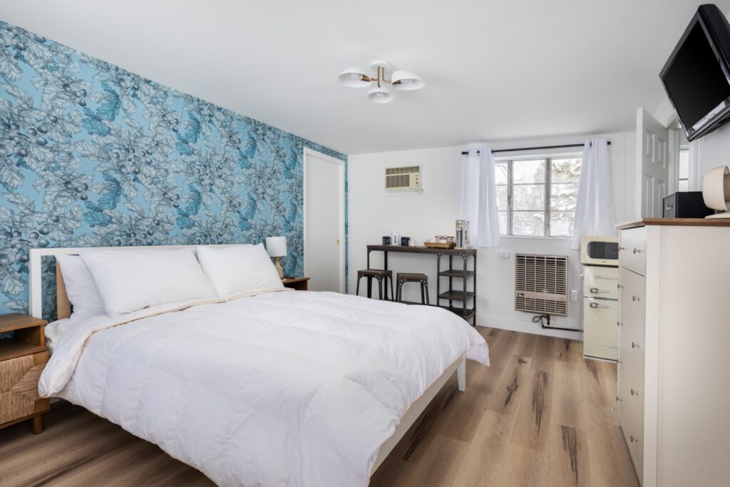 Cozy bedroom with blue floral accent wall