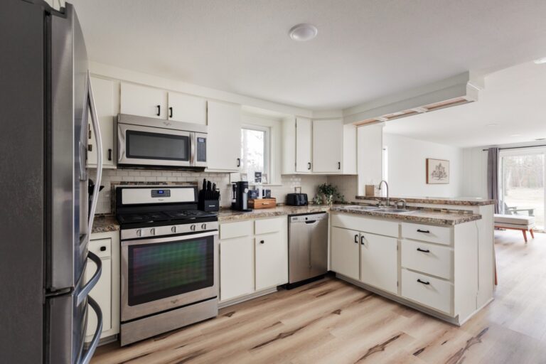 Modern kitchen with stainless steel appliances and cabinets