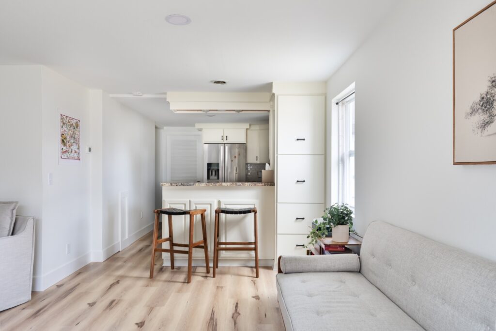 Modern kitchen with barstools and cozy living area