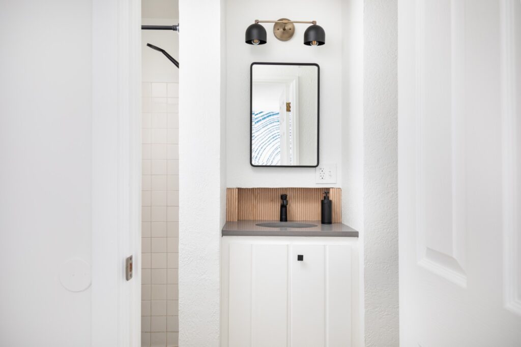 Modern white bathroom vanity with mirror and light