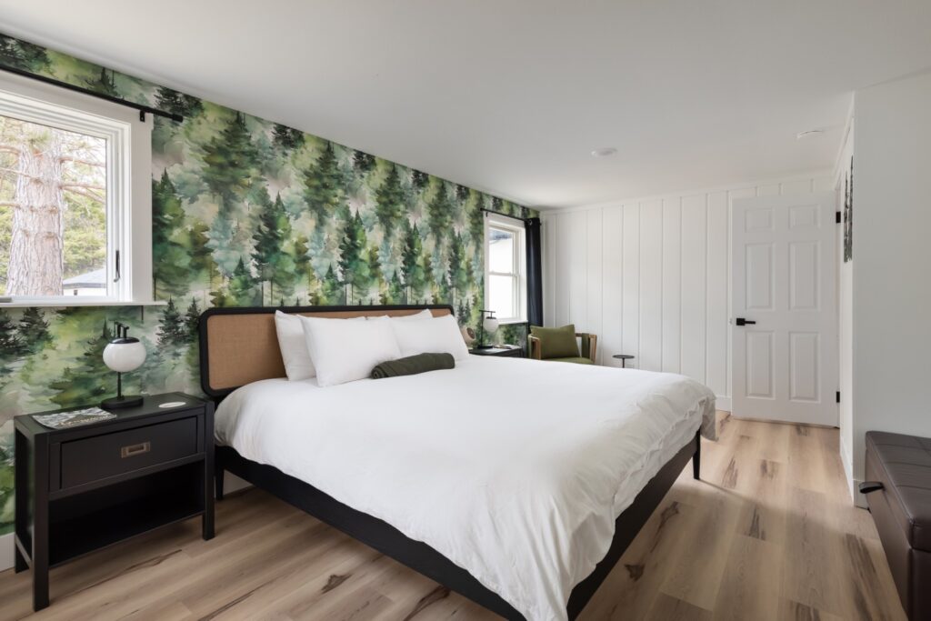 Modern bedroom with forest-themed wallpaper