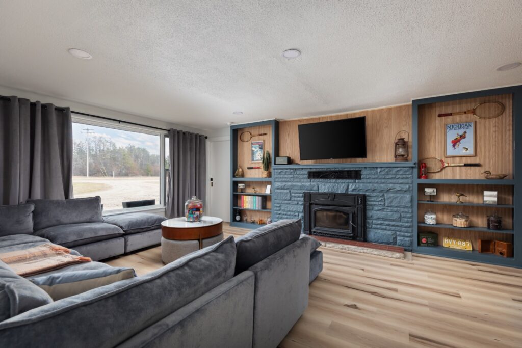 Modern living room with gray sofa and fireplace
