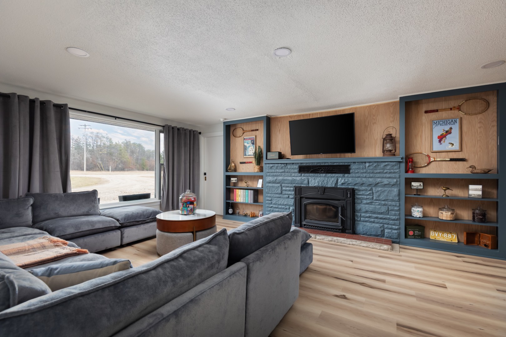 Modern living room with gray sofa and fireplace