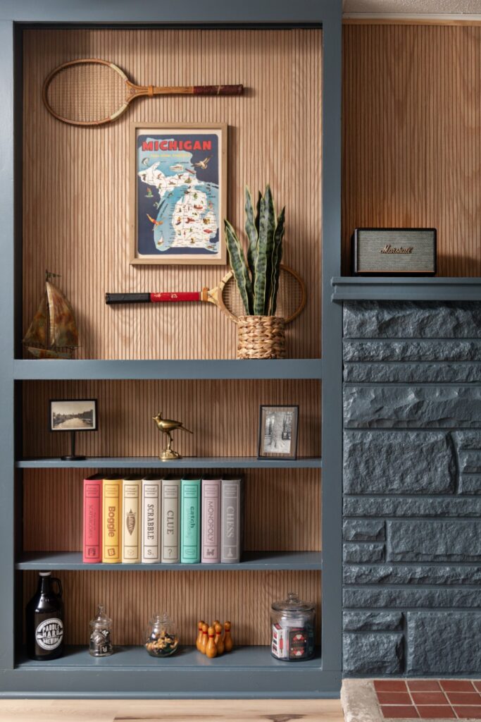 Stylish bookshelf with games, books, and decor items.
