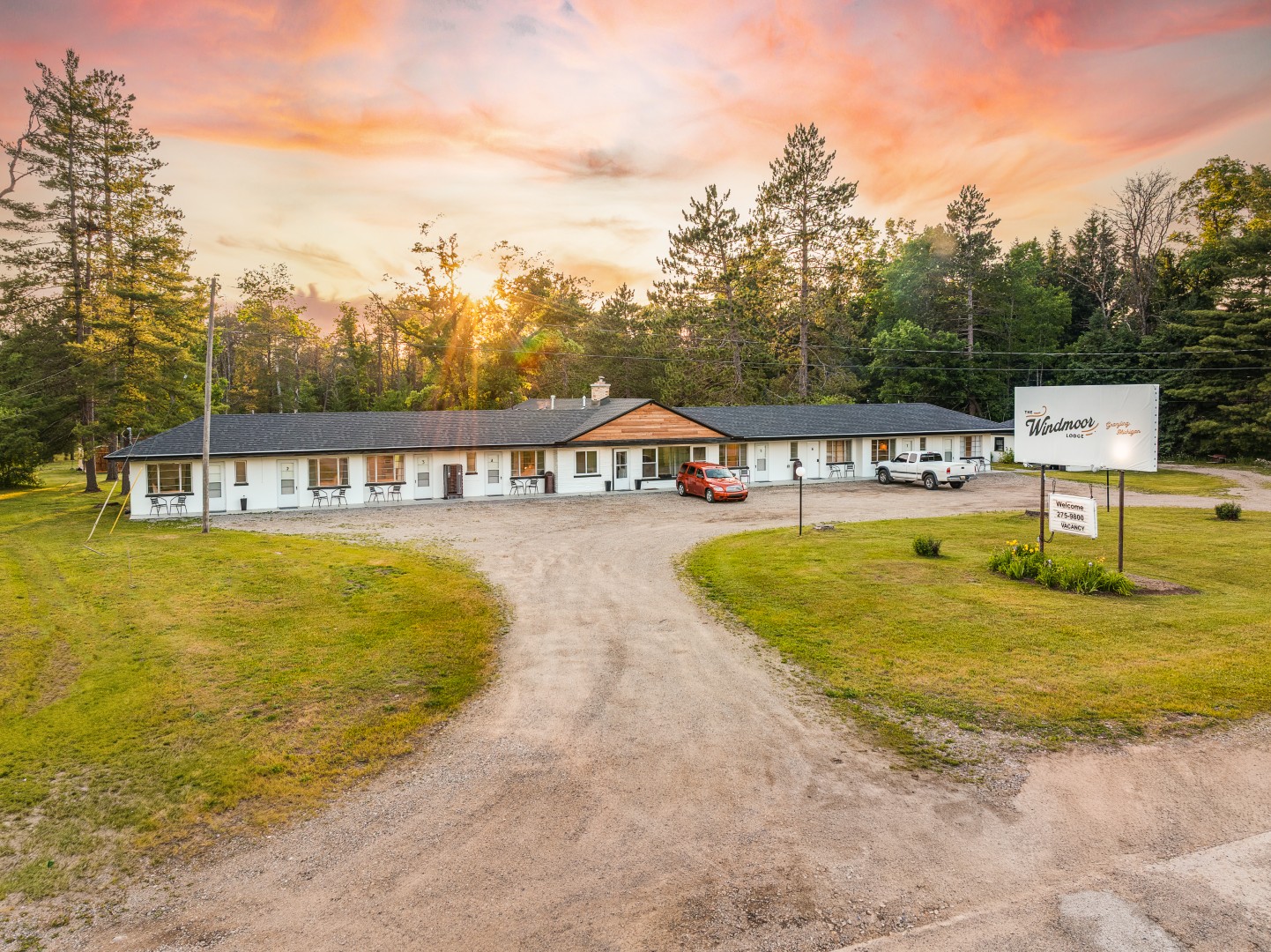 Countryside lodge with cars at sunset