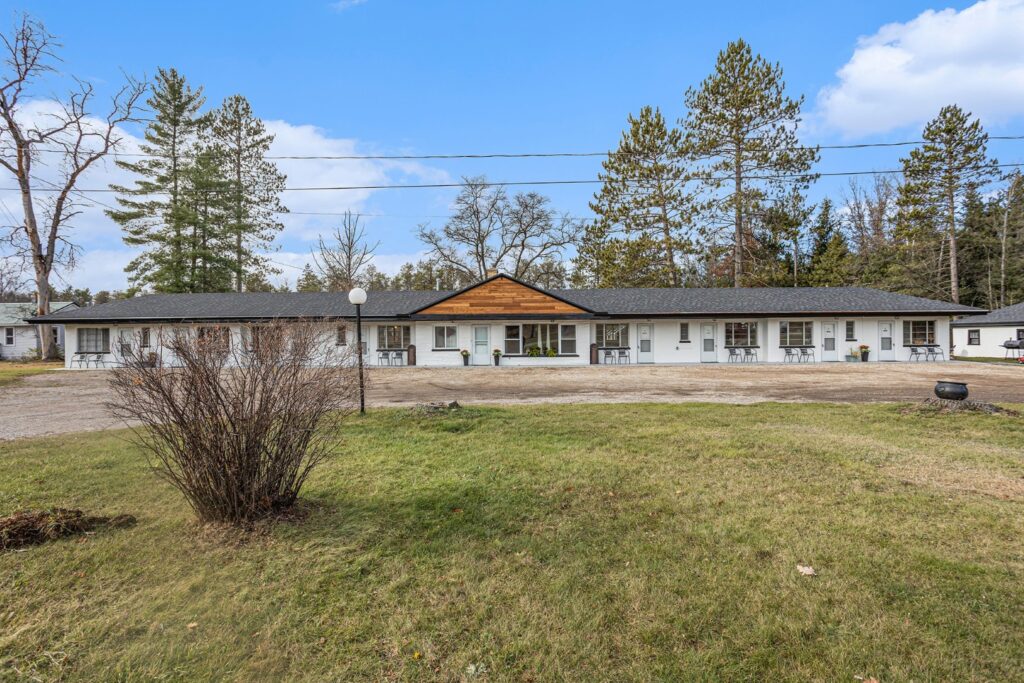 Single-story motel with outdoor seating area