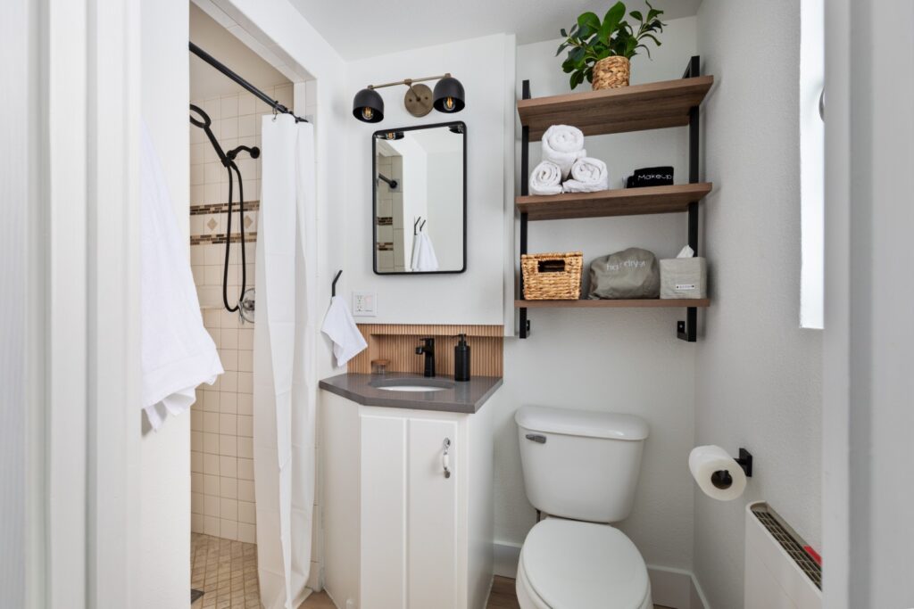 Modern small bathroom with shower and shelves