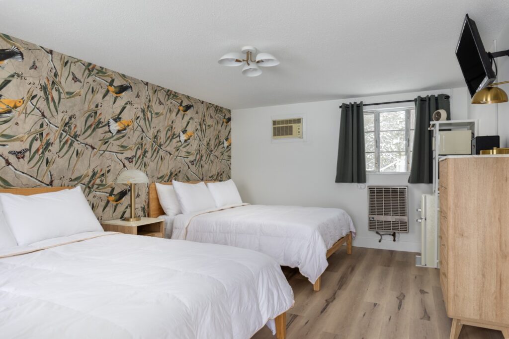 Cozy hotel room with two beds and wallpaper