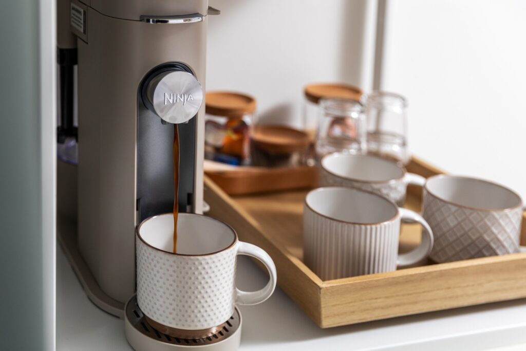 Coffee machine brewing fresh coffee into mug