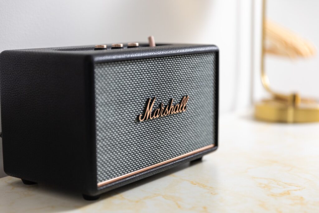 Black Marshall Bluetooth speaker on marble surface