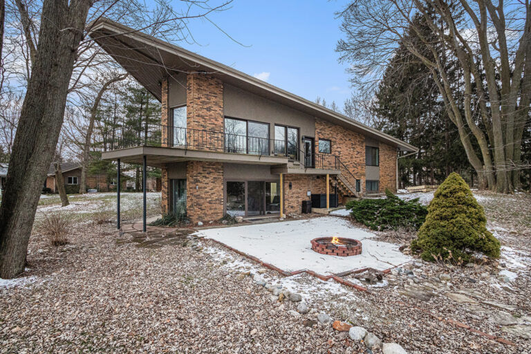 Modern brick house with patio and fire pit