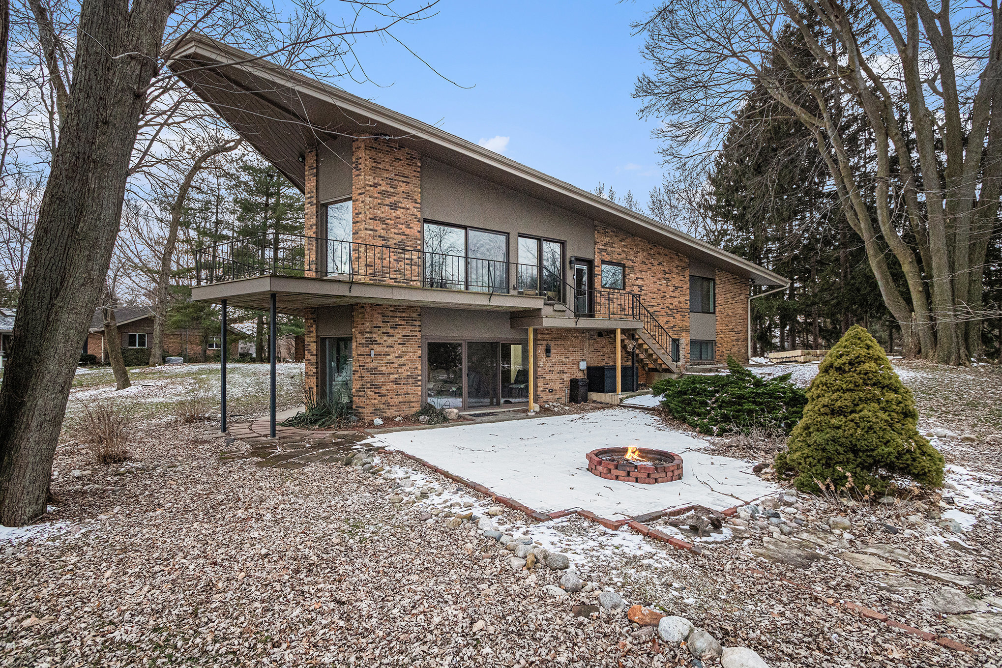 Modern brick house with patio and fire pit