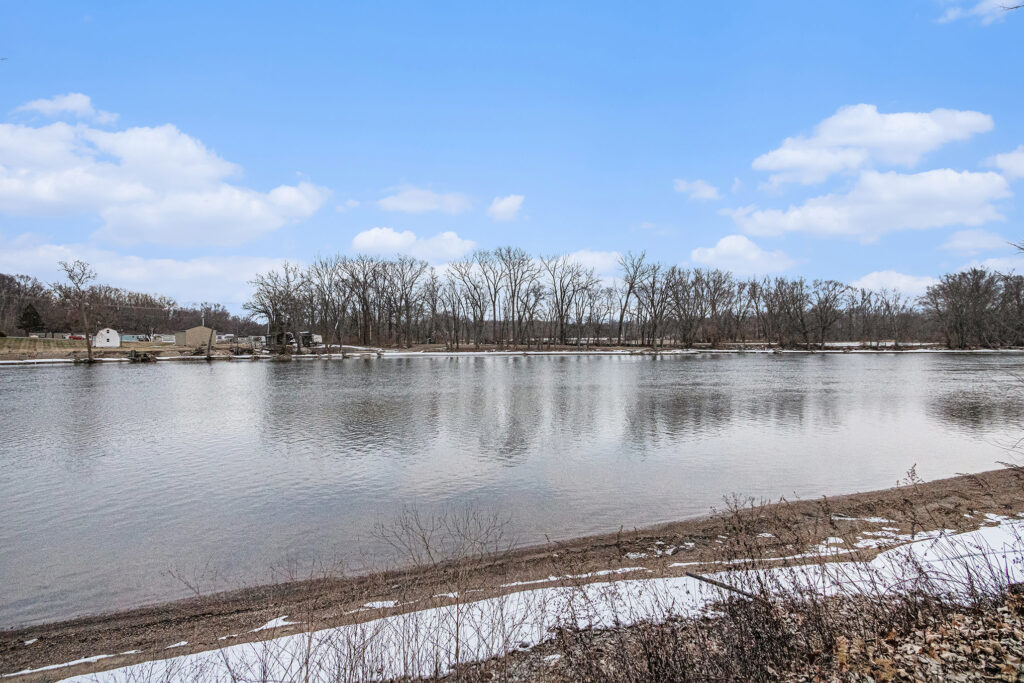 Calm river with trees and blue sky