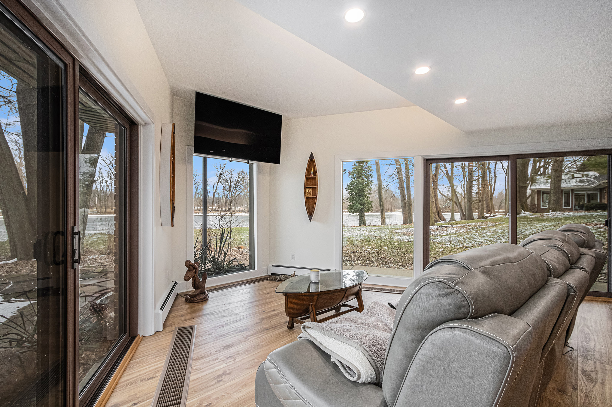 Modern living room with forest view windows
