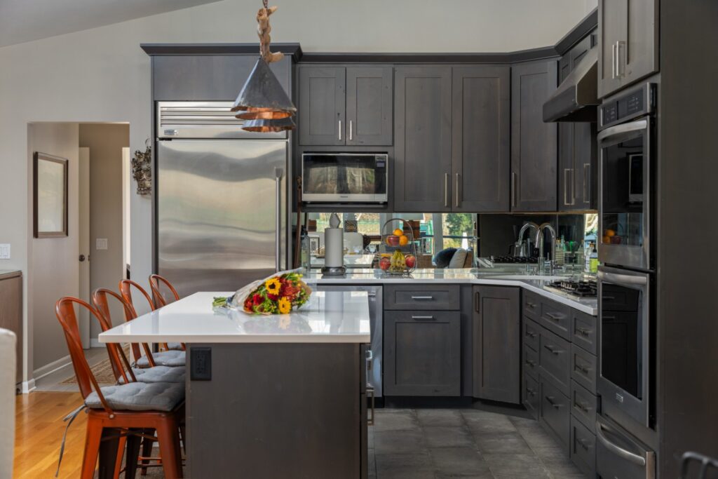 Modern kitchen with dark cabinets and stainless appliances