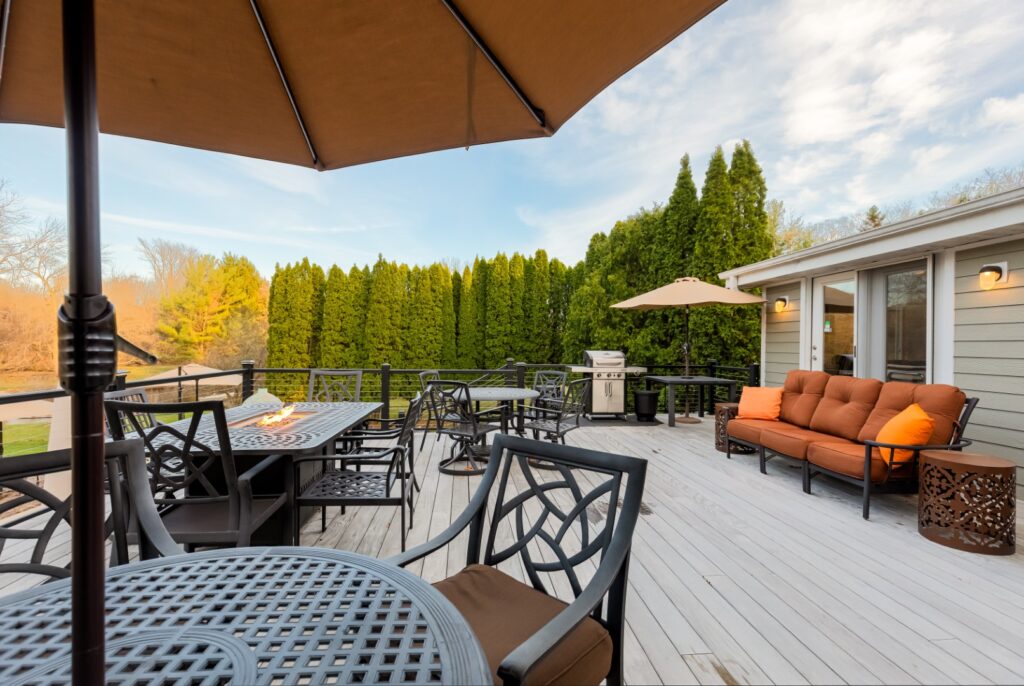 Spacious outdoor patio with seating and grill area