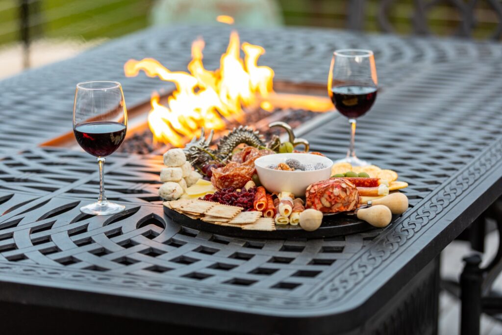 Charcuterie board and wine by outdoor fire pit