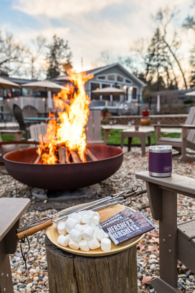 Campfire with s'mores ingredients and outdoor seating