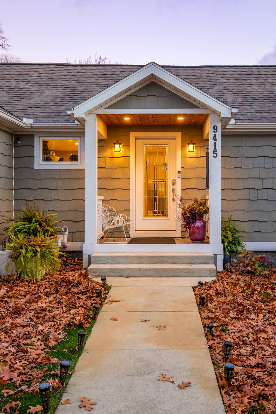 Cozy house entrance with autumn leaves