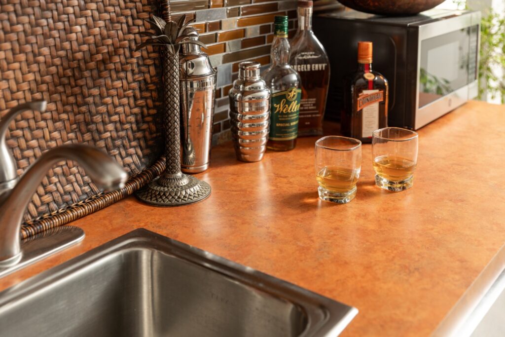 Home bar counter with whiskey and glasses