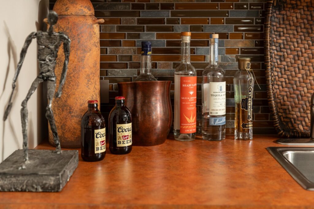Kitchen counter with liquor bottles and decor