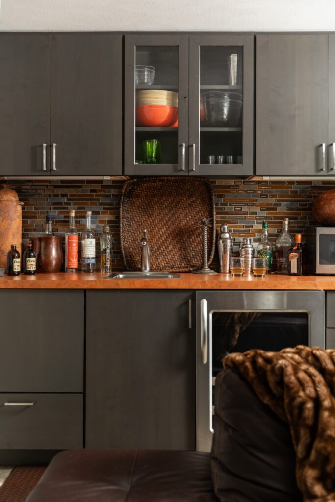 Modern kitchen with dark cabinets and countertop.