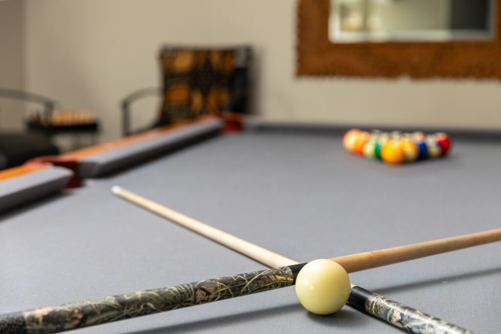 Pool table with cues and racked balls