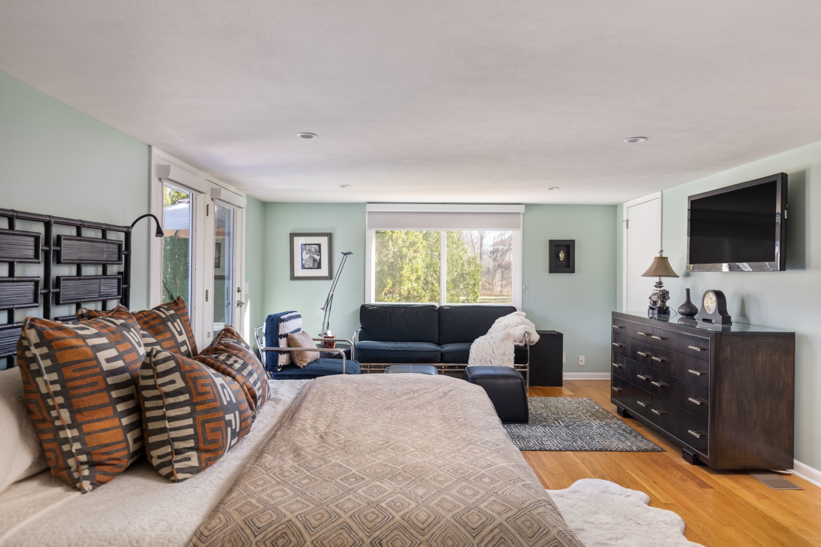 Modern bedroom with large bed and cozy seating area