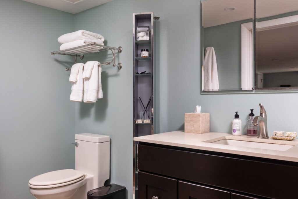Modern bathroom with sink, toilet, and towels