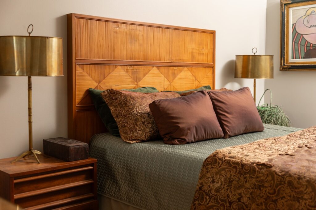 Cozy bedroom with wooden headboard and patterned bedding
